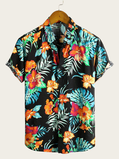 Camisa hawaiana de manga corta Victoria Lemaire con estampado floral tropical en negro, naranja y azul. Tejido de algodón ligero.